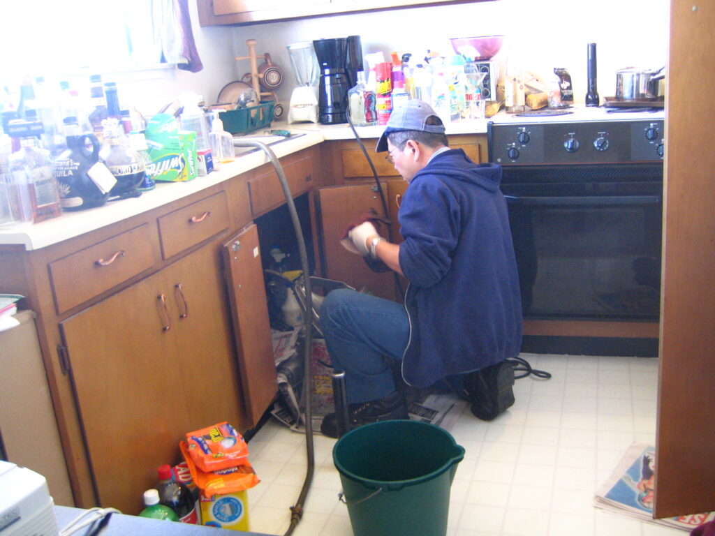 plumber helper jobs in Saskatoon - plumber at work with tools