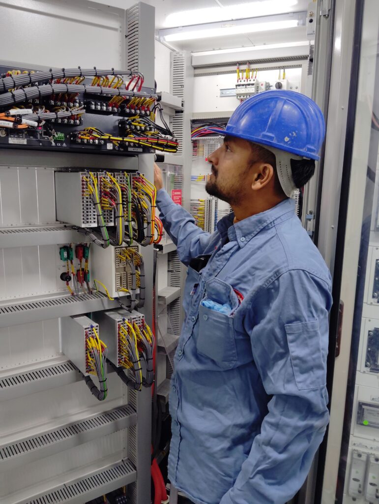 wiring electrician jobs in Edmonton AB - electrician checking control panel wiring