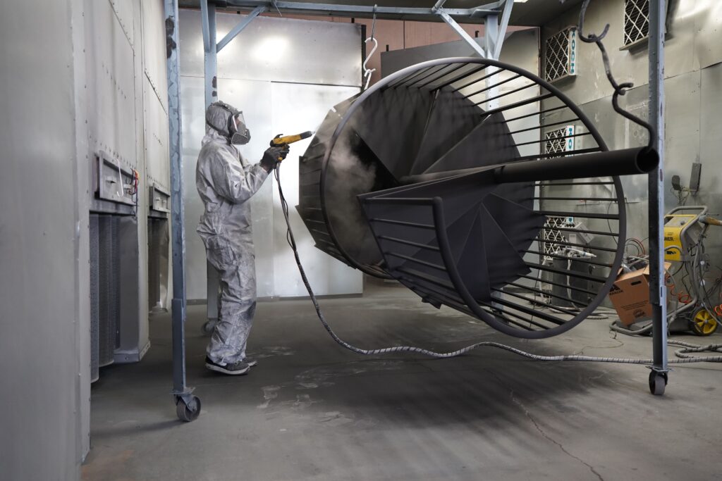 metal product spray painter jobs in quebec - worker spray painting large metal structure